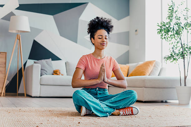 istock Young woman practicing mindfulness meditation at home while enjoying a peaceful and relaxed atmosphere during her leisure time 2215188621