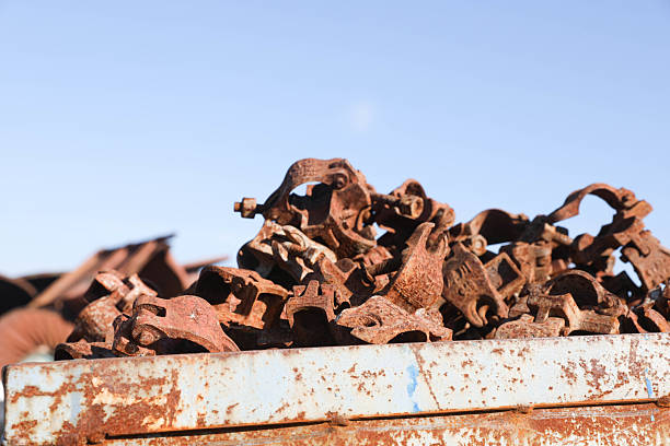 Close up at rusty sucker rod stack which is  junked in material yard. Sucker rod is importance part of Beam pump or Donkey pump operation that use to enhance crude oil production from downhole.