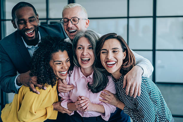 istock Excited coworkers embracing each other during a celebration in the office. 2215189252