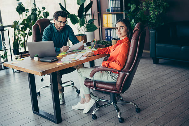 istock Colleagues Engaged in a Professional Discussion at a Modern Workplace Setting with Stylish Office Interior 2215189374