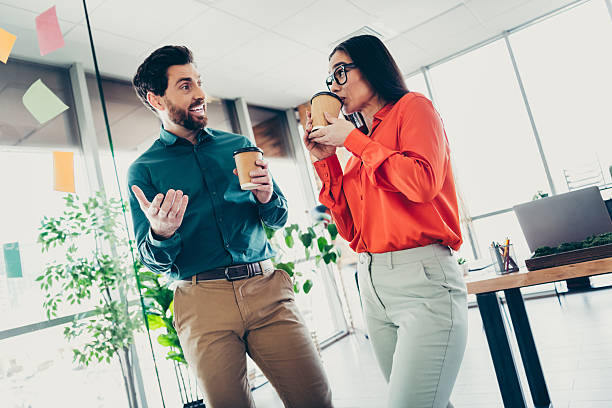 istock Two coworkers enjoy a casual coffee break in the office while collaborating on work and discussing professional topics 2215189488