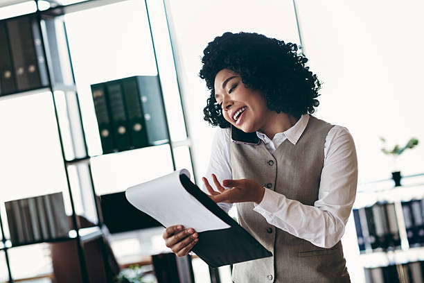istock Businesswoman engaging in a professional conversation while reviewing documents in a modern office environment 2215192786