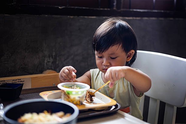 istock Toddler Is Eating Breakfast By Himself 2215194529
