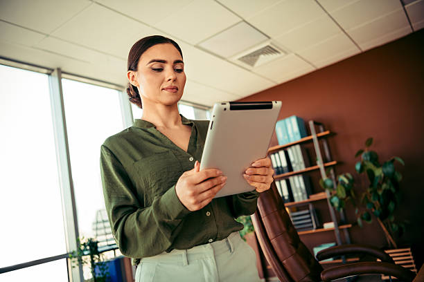 istock Confident businesswoman using a digital tablet indoors in an office workspace, showcasing a professional and elegant environment 2215196305
