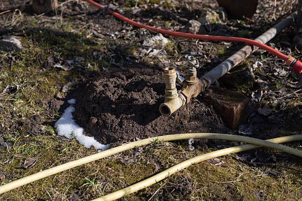 istock A water pipe with a valve and garden hoses on the garden plot. 2215198263