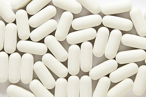 istock Background made of tablets, oval white pills 2215201978