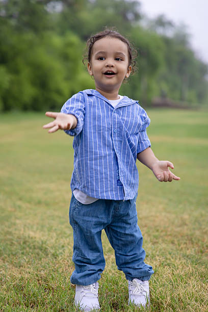 istock adorable indian toddler making hand gestures with cute expression outdoors in morning 2215203034