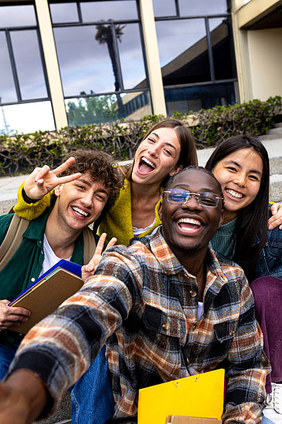 istock Cheerful multi-ethnic students taking selfie outside university building 2215204687