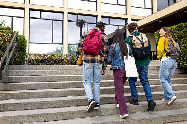 istock University students walking up stairs at college campus 2215207765