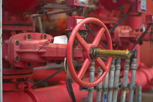 istock Large red industrial valve and pipes fire suppression system. 2215208728