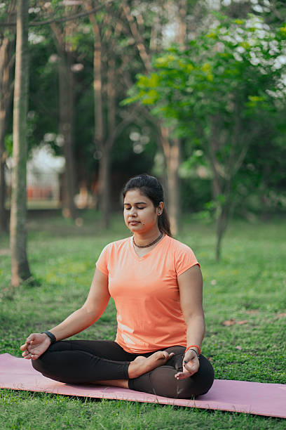 istock Woman Practicing Meditation on Yoga Mat 2215209161