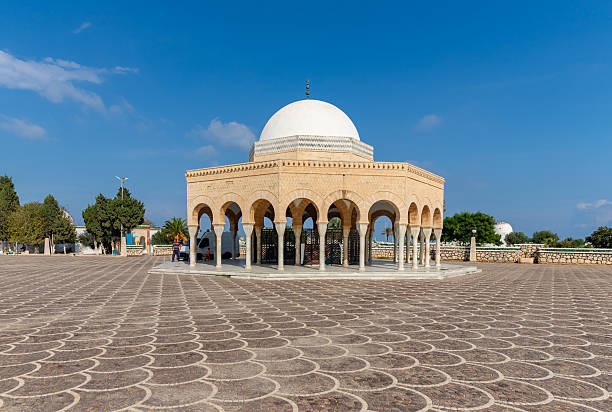 White arabic arch with palms in Hammamet Tunisia.