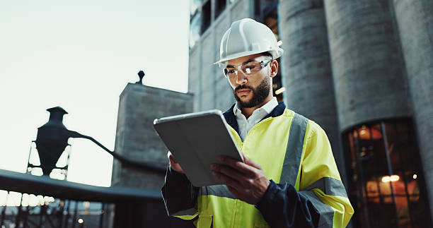 istock Tablet, architect and serious man in city for construction, planning and low angle at dawn. Technology, building and engineer outdoor for maintenance, safety inspection and infrastructure project 2215212187