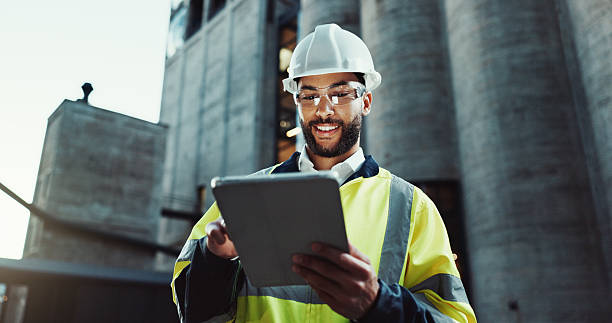 istock Tablet, architect and happy man outdoor for construction, low angle or planning at dawn. Technology, building and engineer in city for maintenance, safety inspection or industrial development project 2215212192