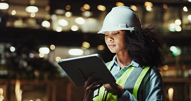 istock Tablet, civil engineer and woman in city for construction, development and planning at night. Technology, building and architect outdoor for maintenance, safety inspection and infrastructure project 2215212255
