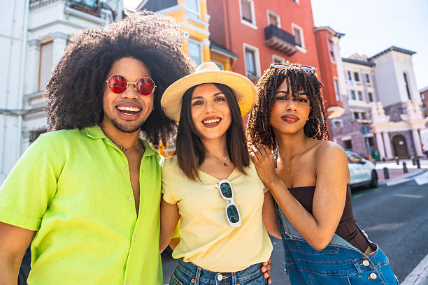 istock Three happy friends smiling together on a sunny day 2215213402