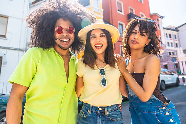 istock Three young adults smiling and having fun together outdoors 2215213403