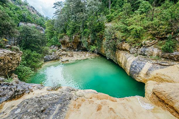 istock Pristine natural rock pools with crystal clear water. River-carved limestone basins creating perfect swimming spots in remote forest wilderness. Pozas de San Martin, Huesca 2215217243