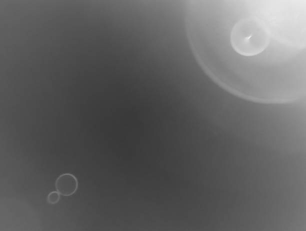 Ethereal darkness, a subtle lens flare hints at distant hope, perfect for melancholic moods, cinematic backgrounds, or abstract digital art.