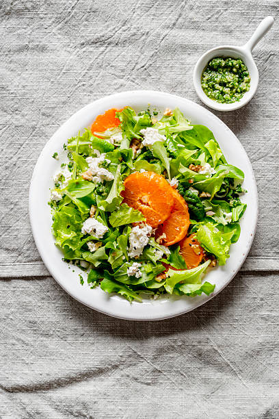 istock A light appetizer or an elegant side dish. Salad prepared with a mix of different varieties of leaves, enriched with orange slices, walnuts and pieces of cheese, feta, with a delicate flavor. 2215223575