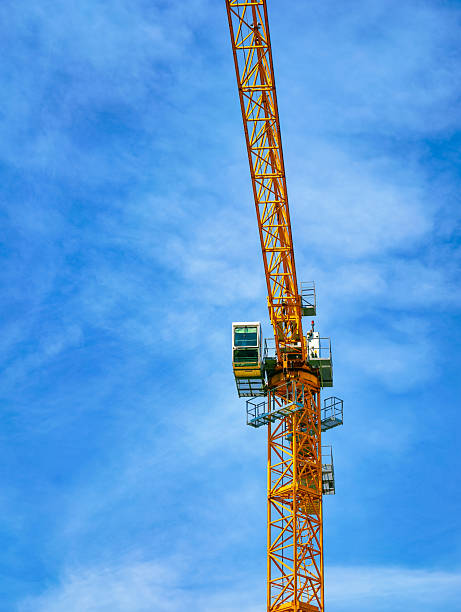 istock Tall Construction Crane Towering Against a Clear Blue Sky, Symbolizing Modern Engineering and Urban Development, Ideal for Depicting Construction and Architectural Progress 2215226750