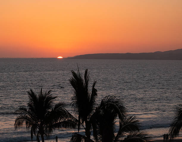 Beautiful sunrise at the entrance of the bay of Puerto Marques in Acapulco. The sun rises over the horizon announcing the arrival of a new day in this Mexican tourist destination.