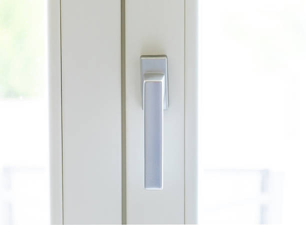 istock Modern metallic handle on a white window frame is letting natural light in 2215231199