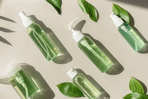 istock Graphic pattern of Transparent Cosmetic bottles, green leaf, natural light and shadow, dispenser, spray with green liquid on beige. Natural Vegan skin care products, Eco-friendly Organic cosmetics 2215231549