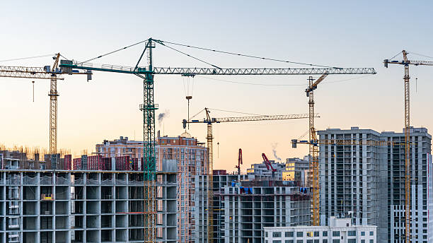 istock Construction site, cranes and multi-storey unfinished buildings at sunrise or sunset 2215234770