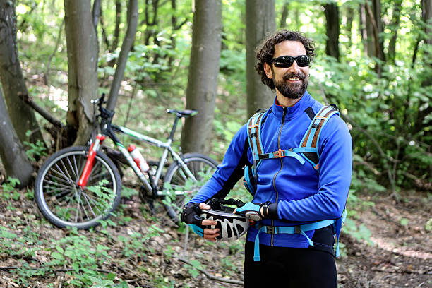 Male cyclist in a forest. About 40 years old, Caucasian man.
