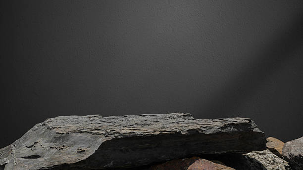 istock Stone, Rock podium isolated on dark cement wall studio light backgrounds 2215244687