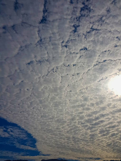 istock Ethereal Landscape: The brilliant azure heavens are dotted with fluffy white clouds pattern 2215245123