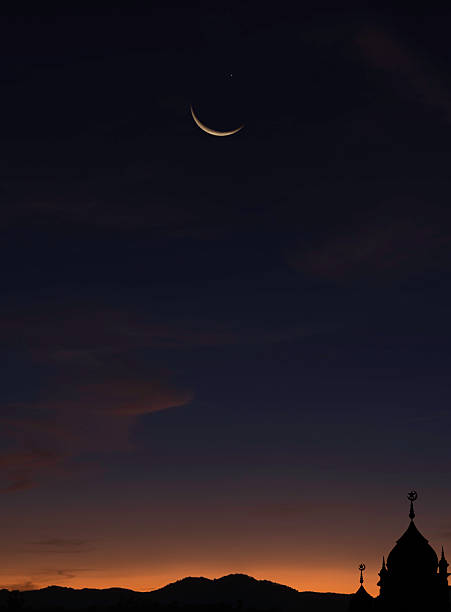 The delicacy of Nature as seen from a thin crescent moon amongst the colored clouds of sunset.