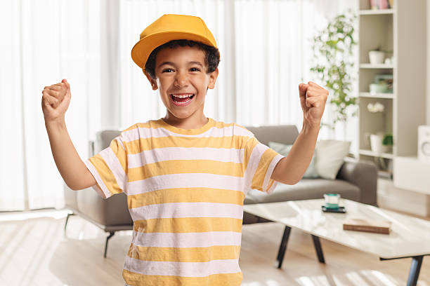 Cute asian boy gesturing happiness at home