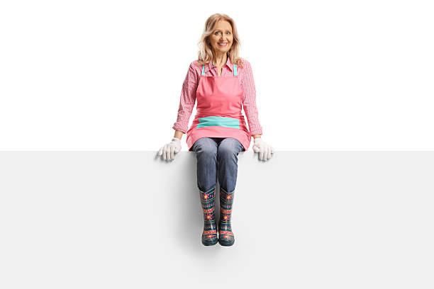 istock Female gardener sitting on a blank panel 2215247570