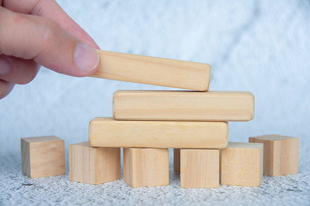istock Hand placing wooden blocks with customizable space for text or ideas. Copy space concept 2215252798
