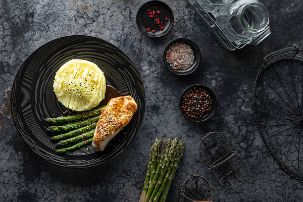 Delicious roasted chicken breast served with mashed potatoes and asparagus