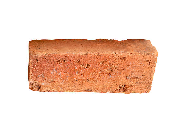 istock Side view of single cracked old red or orange brick isolated on white background with clipping path 2215256428