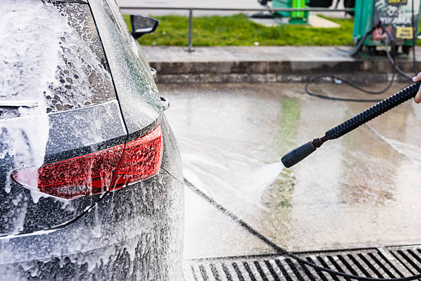 istock Car washing process at a self-service station with foam and water spray 2215257425