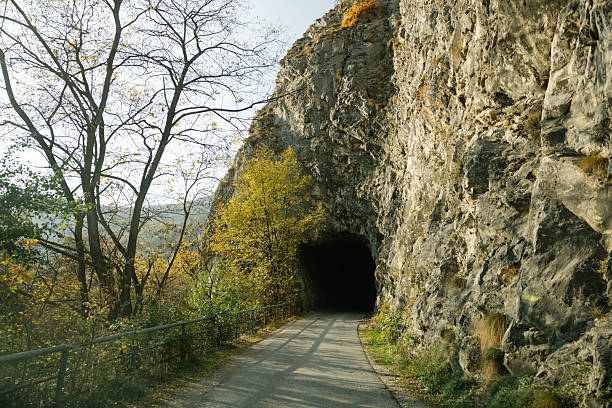istock Mountain road through tunnel and rocks 2215259182