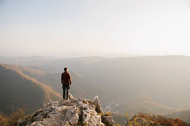 istock Man standing at the cliff with scenic view 2215259206