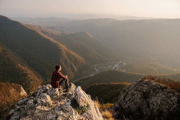 Man sitting at the cliff, beautiful landscape in background. Ovcarsko-Kablarska Klisura Serbia