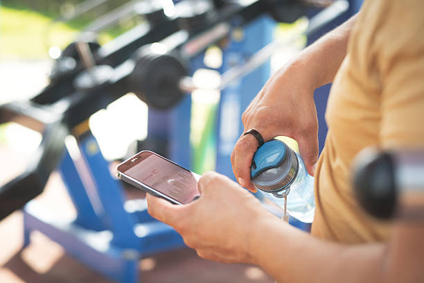 istock Man with smart ring and smartphone at outdoor gym 2215259241