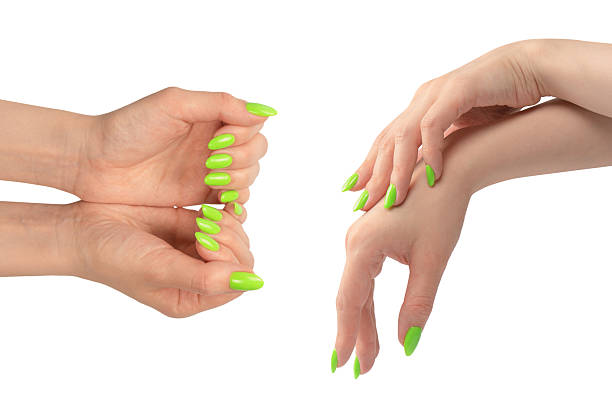 istock Hand of a woman with green naols hold some tiny or thin object. 2215260282