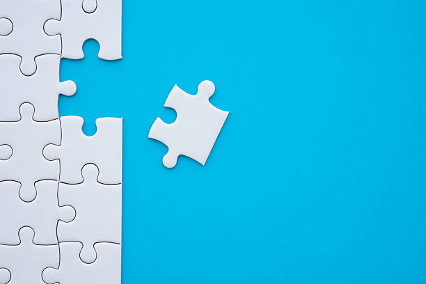 istock Jigsaw puzzle is playing to complete task on blue background. 2215261294