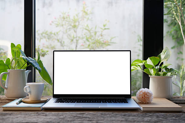 istock Laptop with white screen and coffee cup and pink flower, cozy indoor work space 2215263453