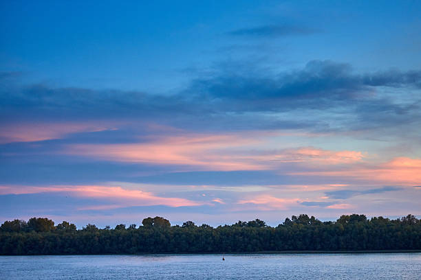 istock Sunset over danube river delta. Cloudy sky at the evening over river landscape 2215263504
