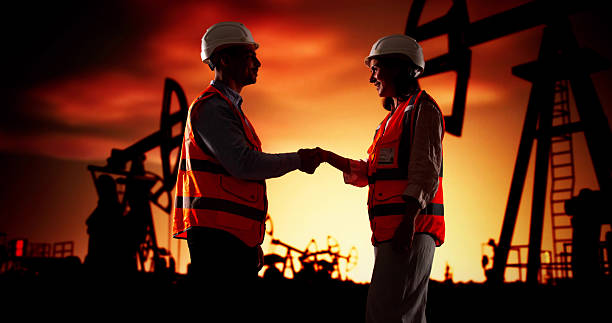 istock Corporate Engineers Shaking Hands At Oil Rig 2215268351