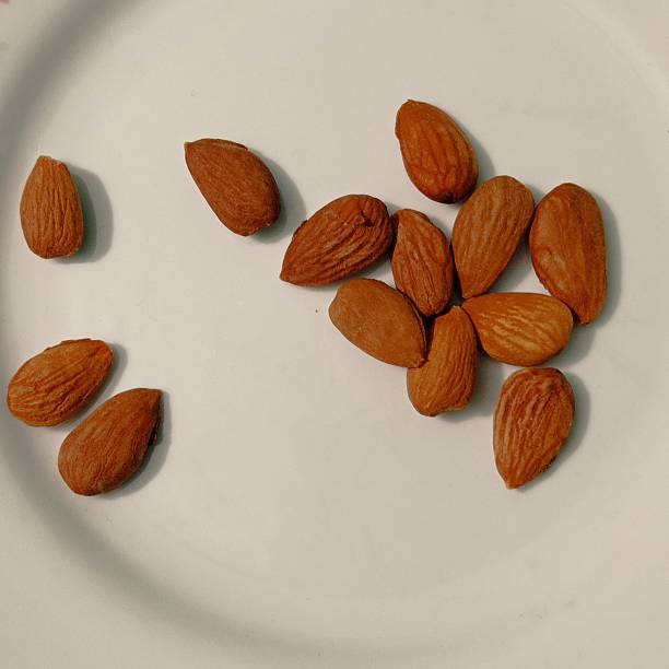 istock A handful of almonds on a white surface. 2215268867