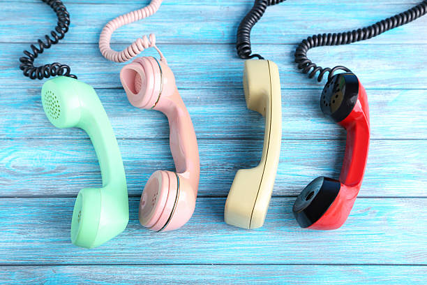istock Telephone handsets on blue wooden table 2215272087